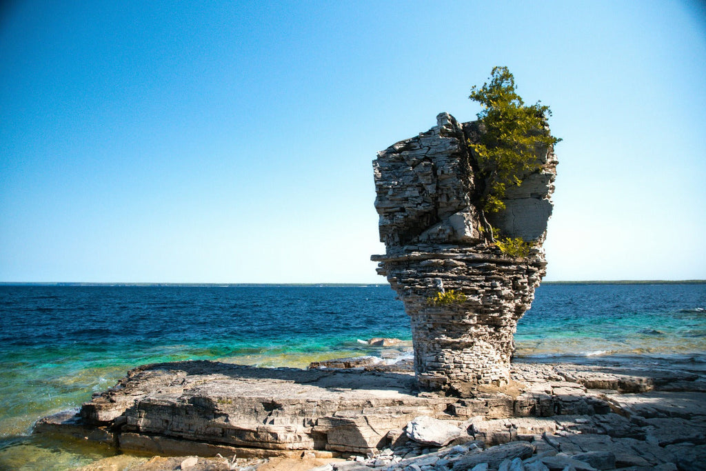 a rock outcropping in the middle of the ocean