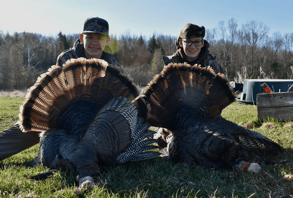 youth holding turkeys in their hands