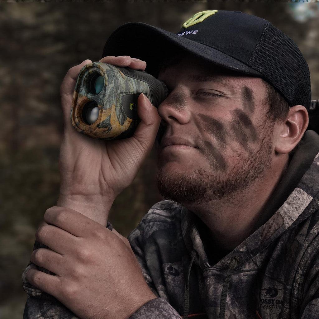 Man wearing a hat and using binoculars, showcasing the 270 Degree 3 Full Panels See Through Hunting Blind and Rangefinder Bundle for optimal outdoor hunting experiences.