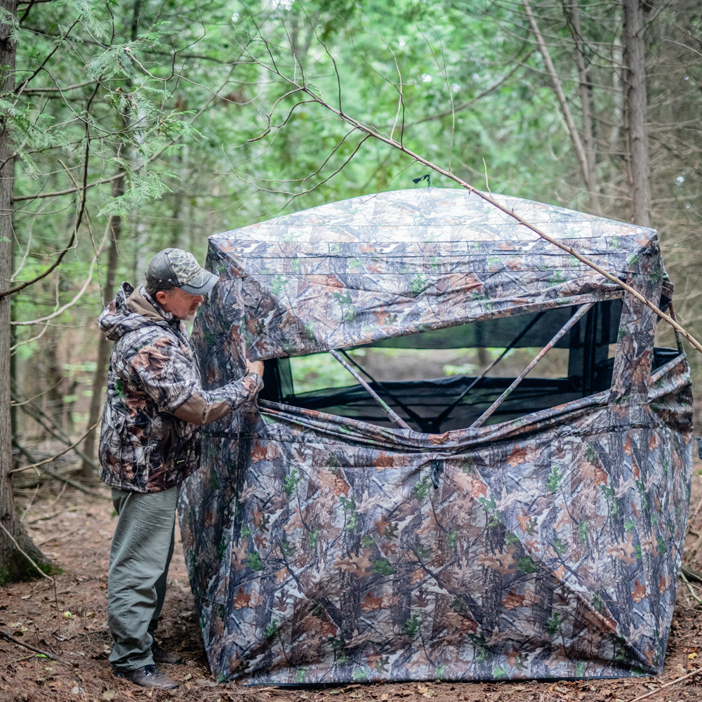 A hunter stand beside the blind