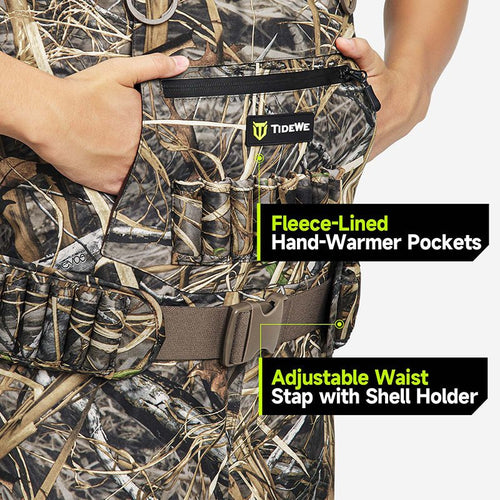 Person wearing AquaWade Pro Insulated Duck Waterfowl Hunting Chest Waders, featuring a camouflage vest, hand-warmer pockets, and a belt for quick reloading.