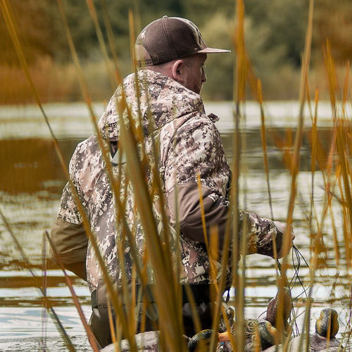 A duck hunter turns his back on you