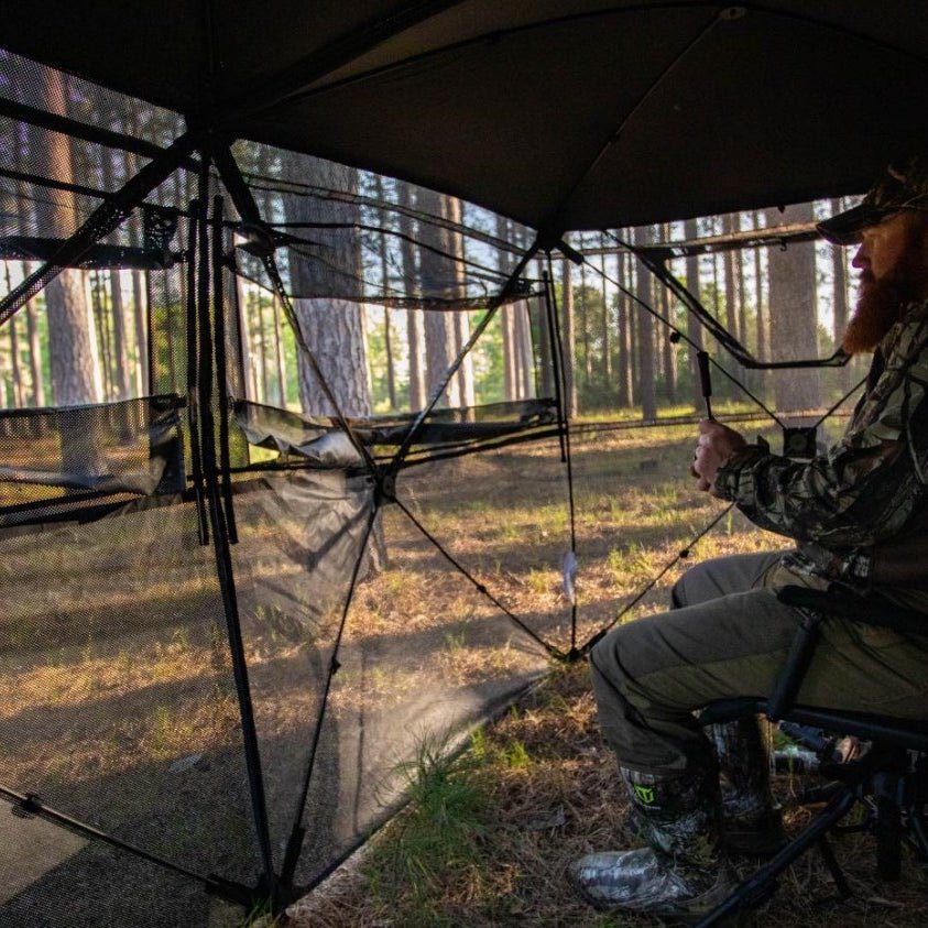 A man sitting inside a see through blind