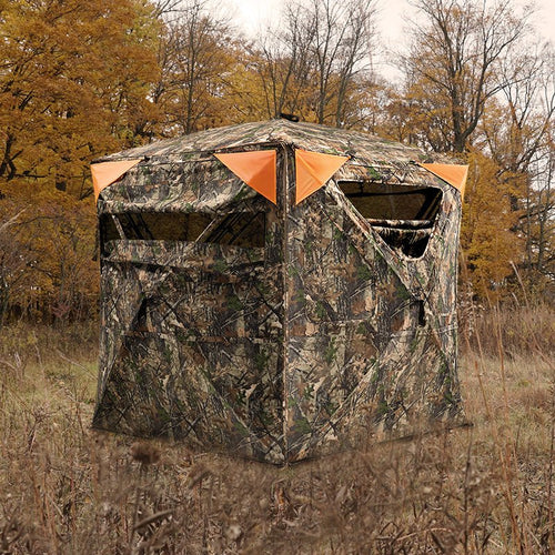 TIDEWE camouflage hunting blind with orange safety panels in a forest clearing.